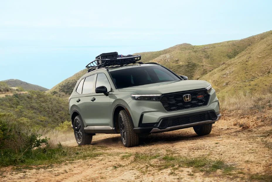 Honda CR-V TrailSport Hybrid with a roof basket on a grassy trail